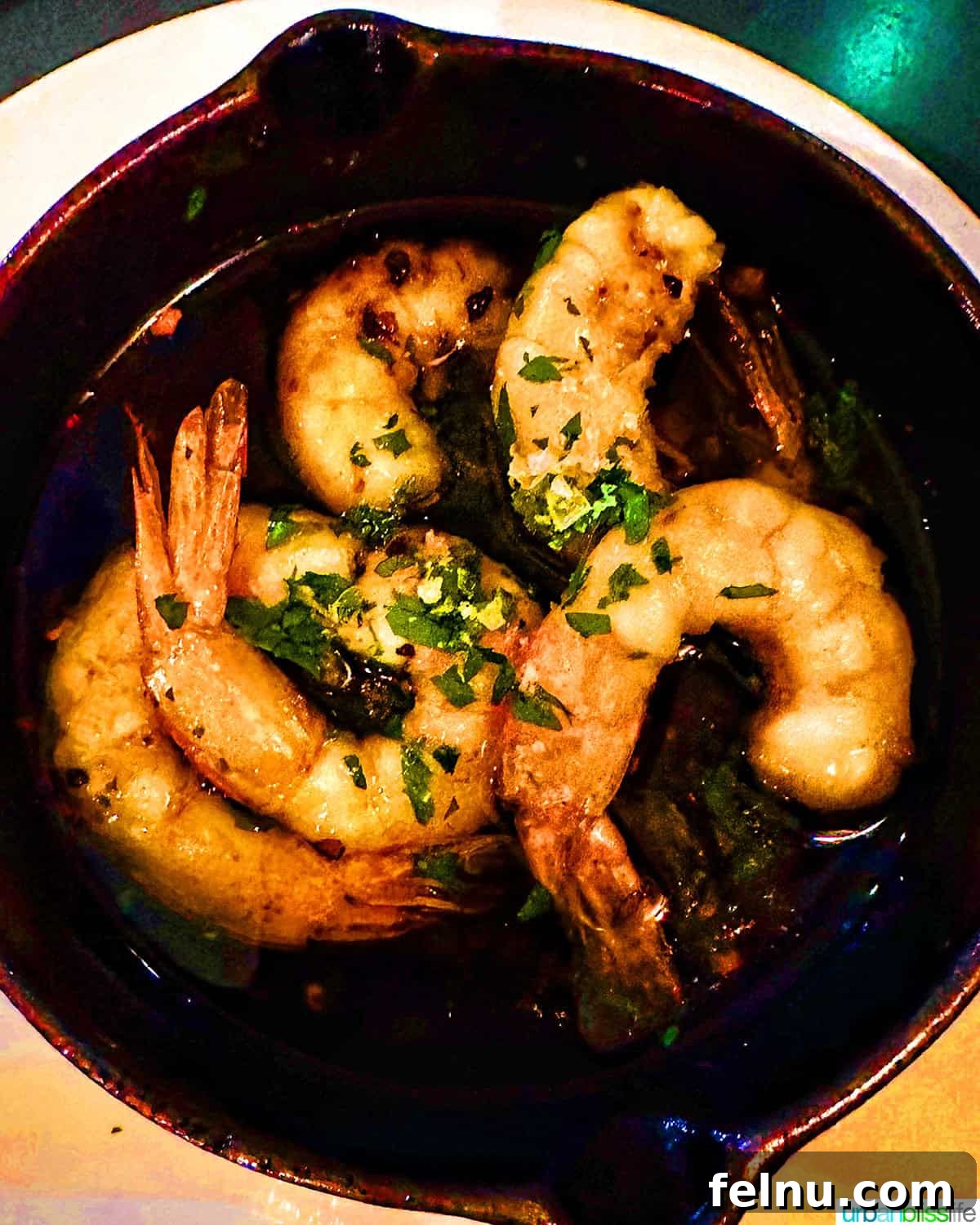 London's Culinary Gems 12 Sizzling garlic prawns, a popular and flavorful Spanish tapa, served in a ceramic dish at Brindisa London.
