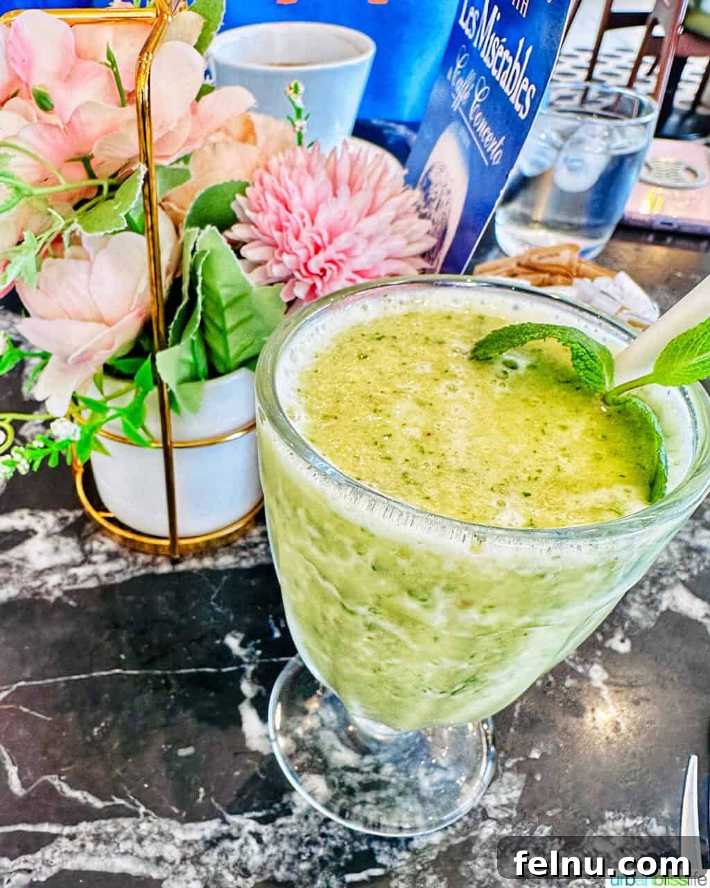 London's Culinary Gems 15 A refreshing green smoothie served in a tall glass, a healthy beverage choice at Caffe Concerto London.