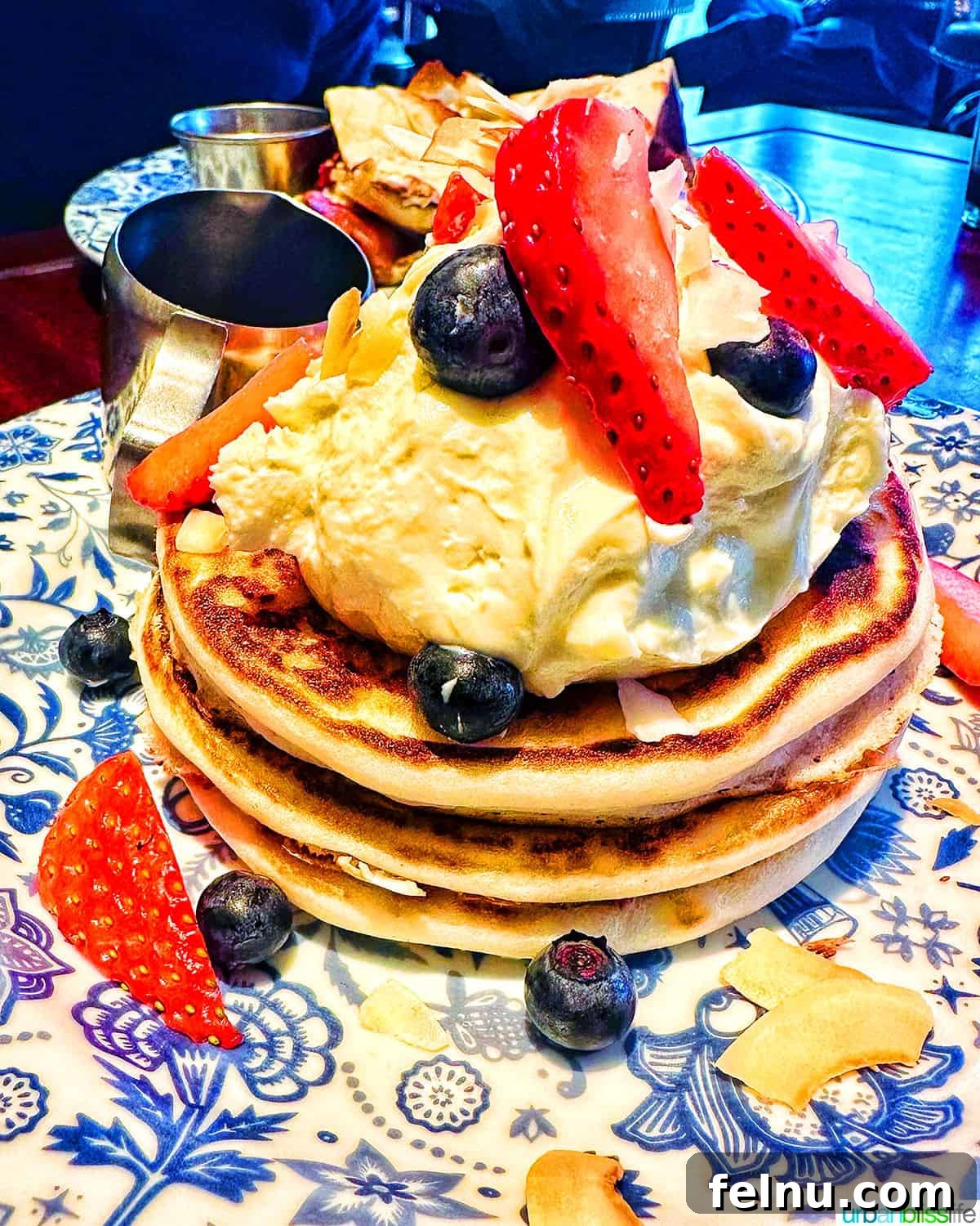 London's Culinary Gems 16 A delicious stack of Uttapam, an Indian savory pancake, served with fresh berries and whipped cream at Dishoom in London.