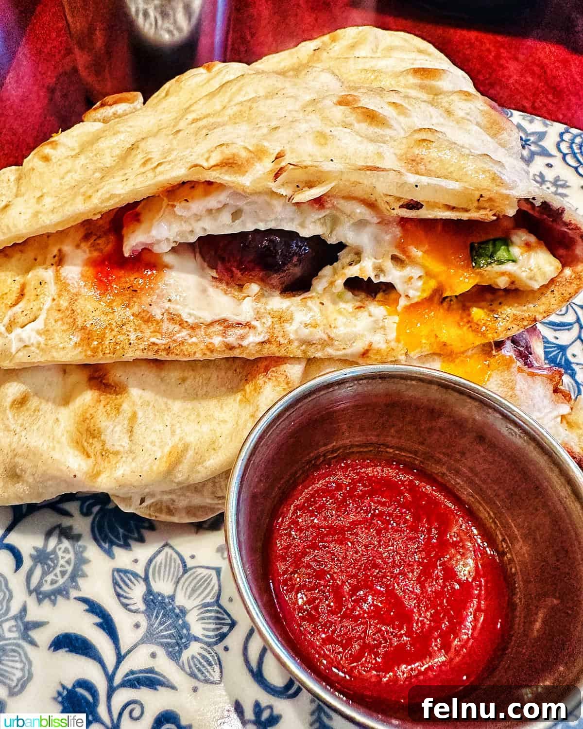 London's Culinary Gems 17 A mouth-watering sausage naan roll, featuring a freshly baked naan filled with flavorful sausage, cream cheese, and chili jam, at Dishoom in London.