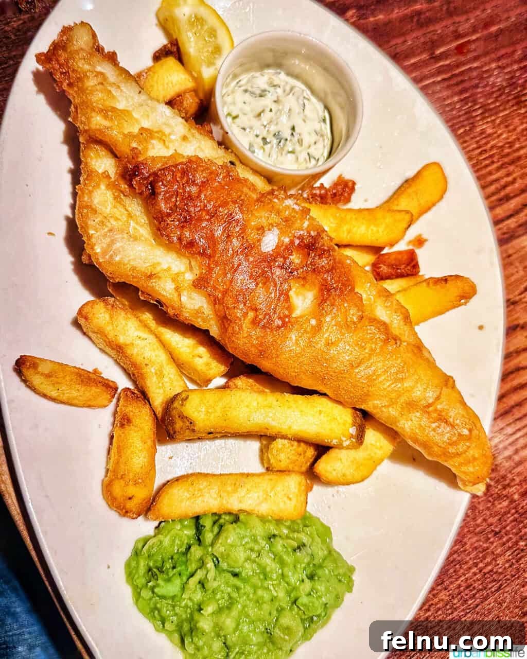 London's Culinary Gems 20 A classic plate of fish and chips, accompanied by traditional mushy peas, from Gordon Ramsay's Heddon Street Kitchen in London.