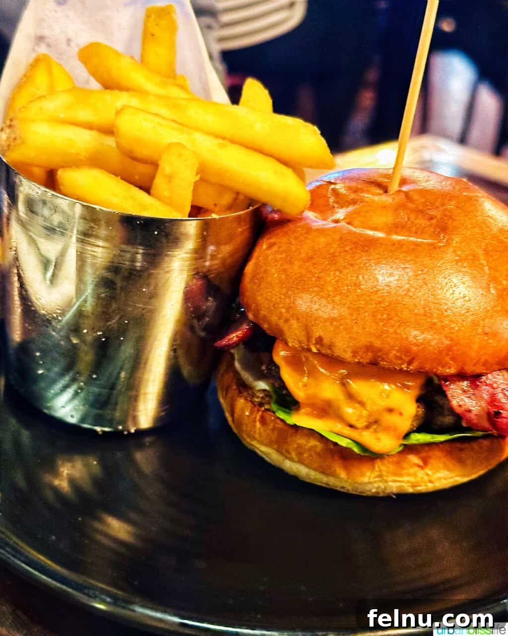 London's Culinary Gems 21 A gourmet burger and crispy fries, a satisfying meal from Gordon Ramsay's Heddon Street Kitchen in London.