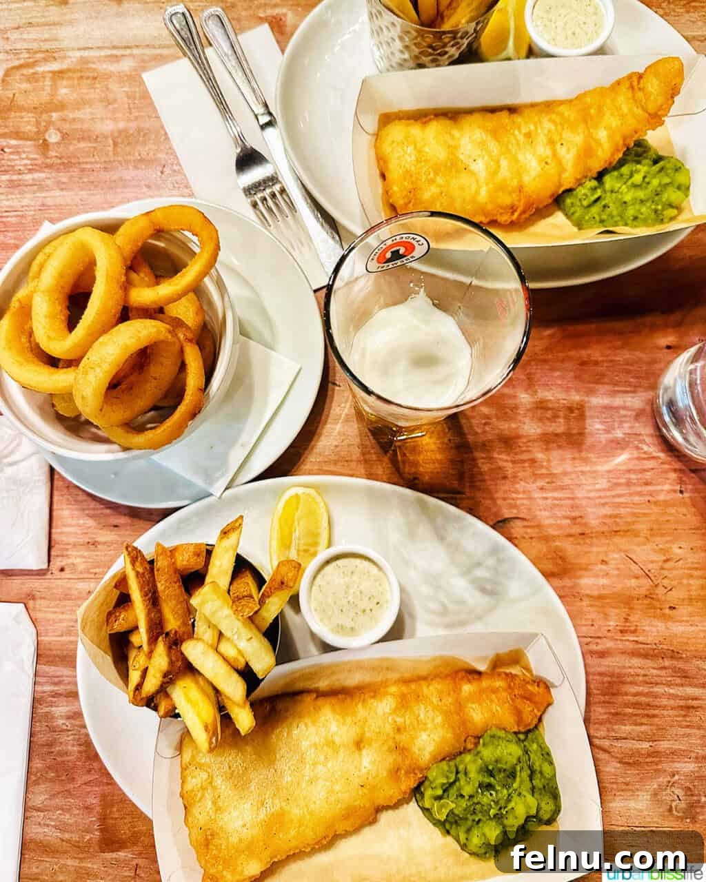 London's Culinary Gems 26 Classic fish and chips, a traditional British pub staple, served with a lemon wedge and tartar sauce at the White Hart Pub.