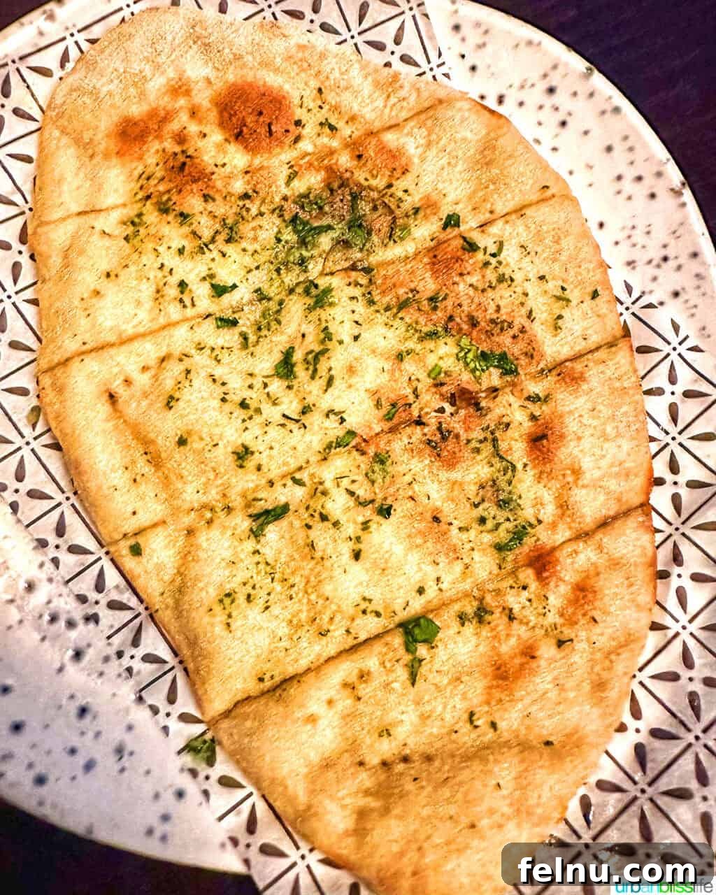 London's Culinary Gems 5 Warm and fragrant garlic flatbread, perfectly seasoned, served as an appetizer at Bella Italia in London.
