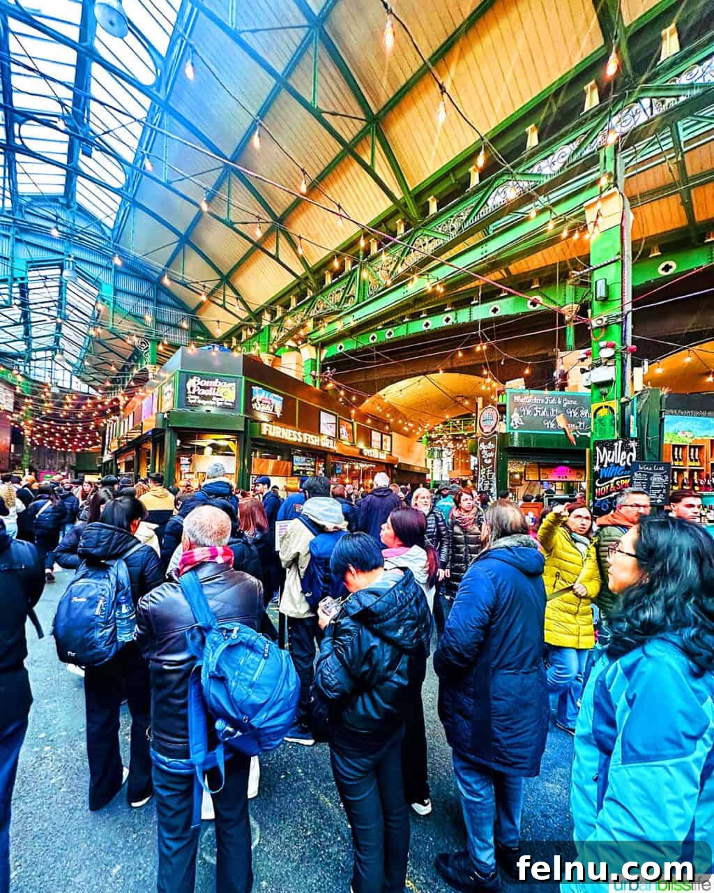 London's Culinary Gems 6 A bustling scene at Borough Market, with crowds of people exploring the various food stalls and vendors.