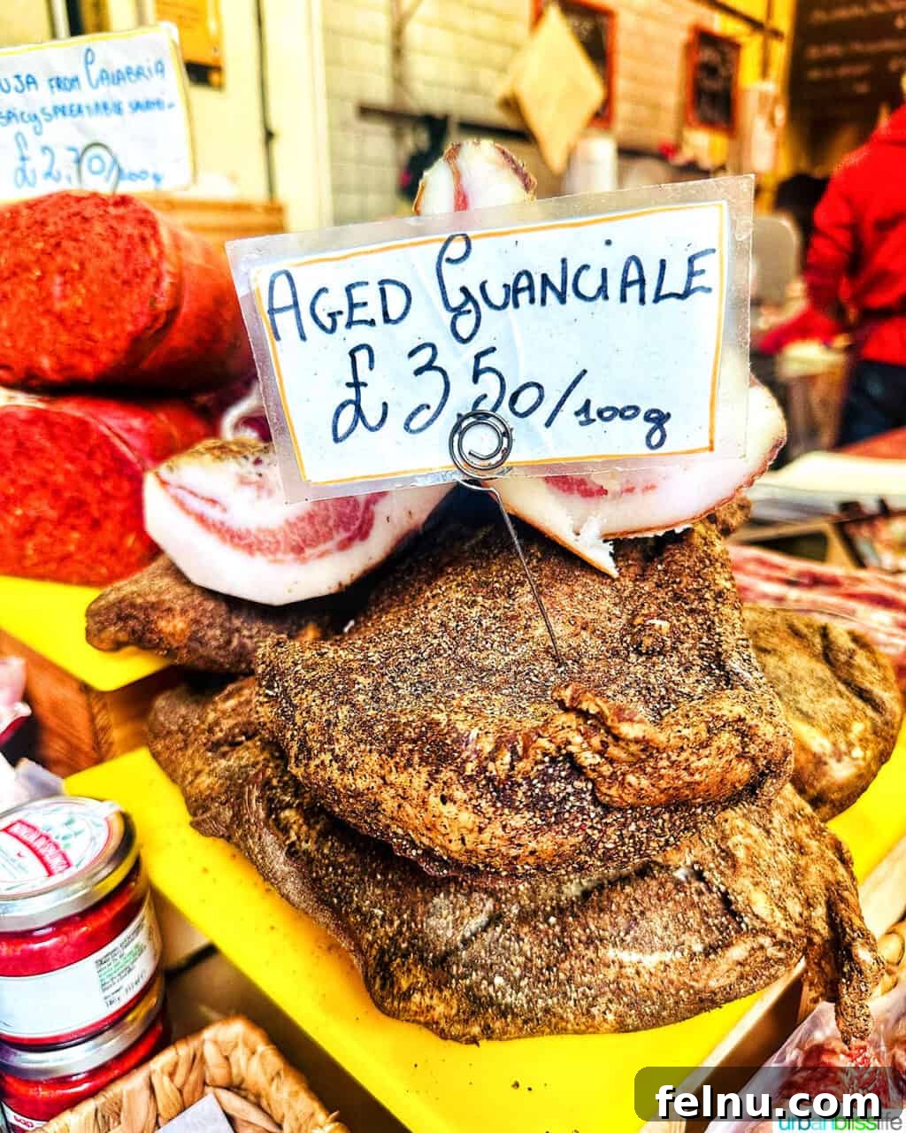 London's Culinary Gems 7 Artisan guanciale, a cured Italian pork product, displayed at a charcuterie stall in Borough Market.