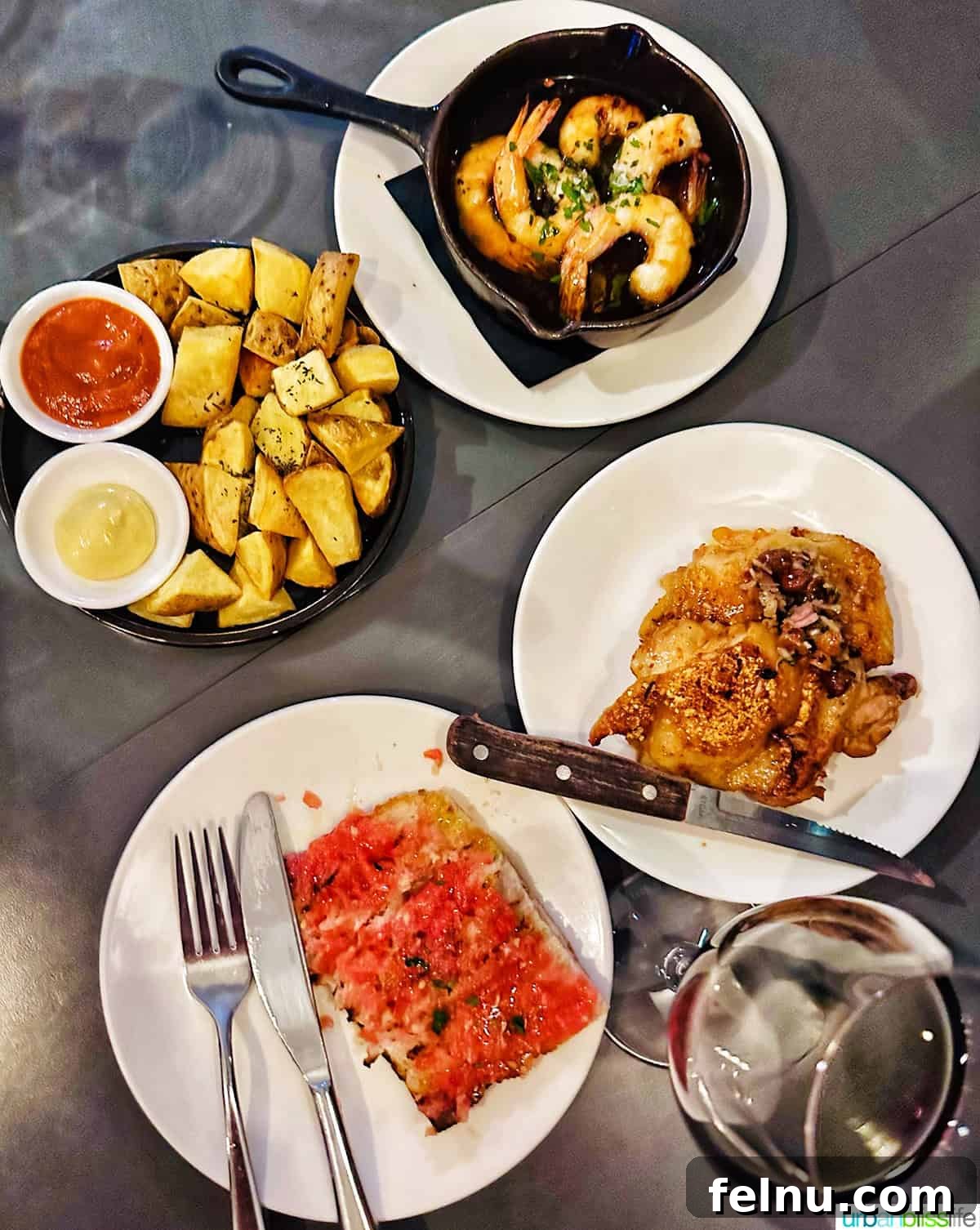 London's Culinary Gems 10 An overhead view of four delicious Spanish tapas plates, artfully arranged on a table at Brindisa in London, ready for sharing.