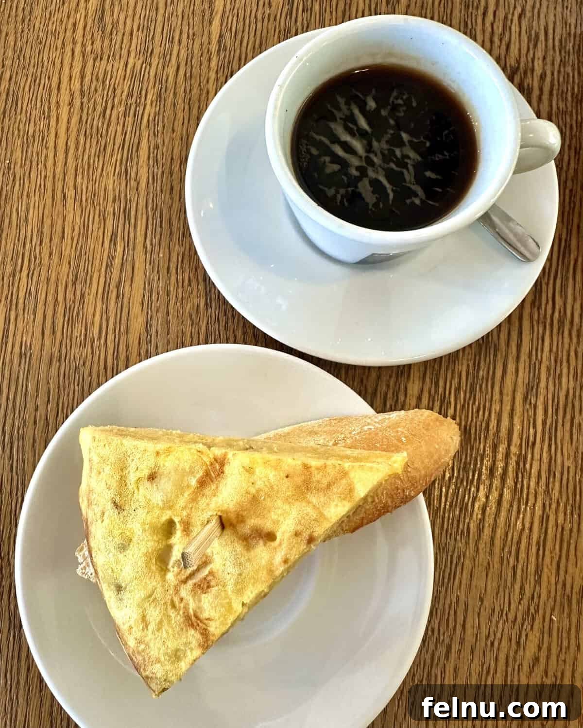 12 Essential Pintxos to Taste 12 A comforting slice of Tortilla de Patatas, the classic Spanish potato omelet, served with a cup of coffee.