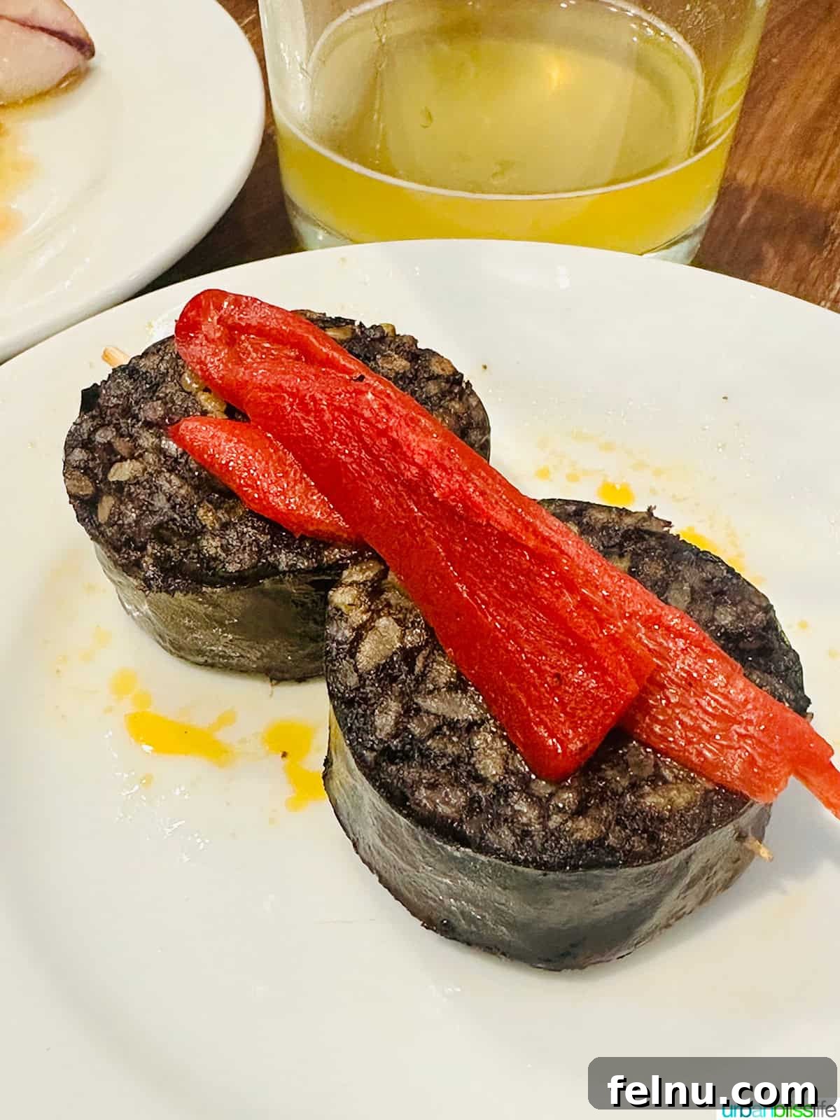 12 Essential Pintxos to Taste 14 A savory Morcilla pintxo: slices of blood sausage served as a flavorful small bite.