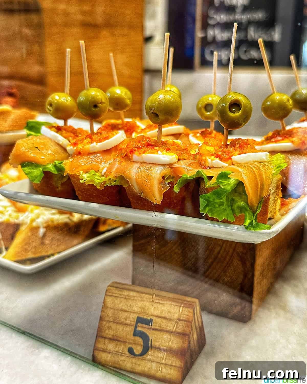 12 Essential Pintxos to Taste 3 A selection of colorful pintxos artfully arranged on a serving plate, highlighting their small, intricate nature.