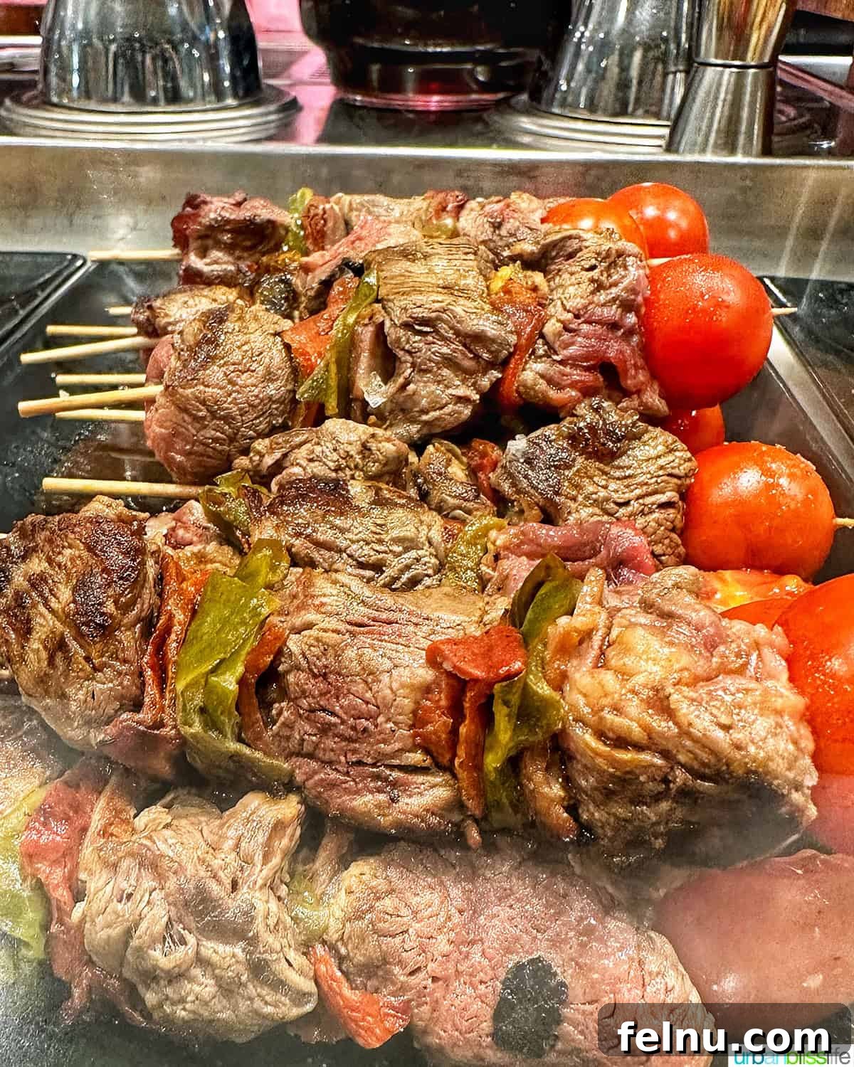 12 Essential Pintxos to Taste 8 Gourmet pintxos skewers featuring succulent slices of sirloin steak accompanied by fresh vegetables.