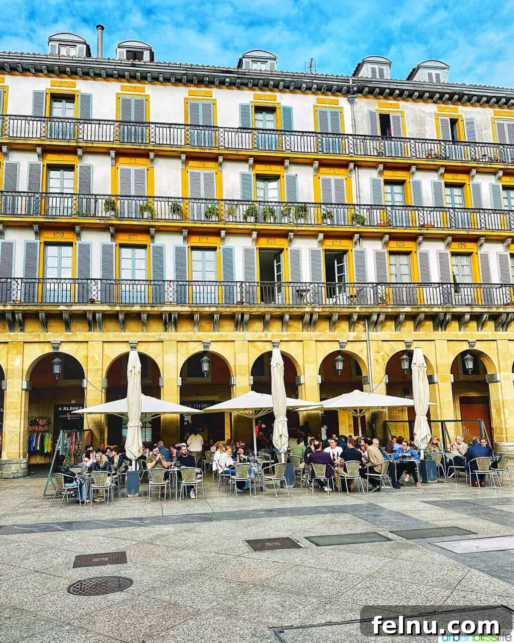 Top Experiences in San Sebastian 4 Lively square in Old Town San Sebastian, Spain, with a beautiful yellow building