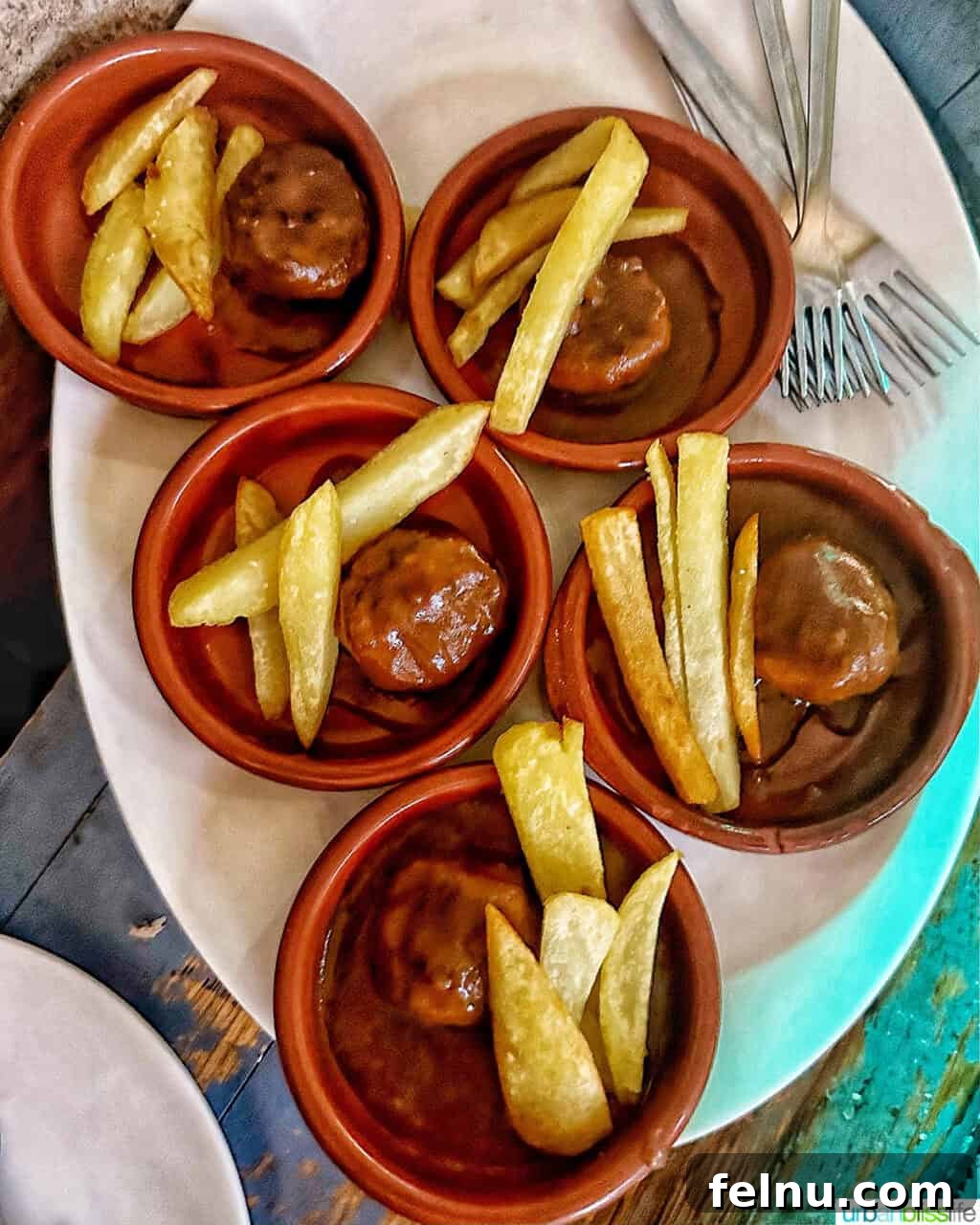 The Ultimate Pintxo Crawl: Bilbao's Best Bites 9 An array of pintxos served with French fries, offering a casual and satisfying dining experience.
