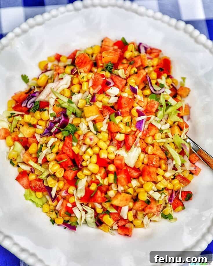 Colorful summer slaw featuring corn, peaches, and tomatoes
