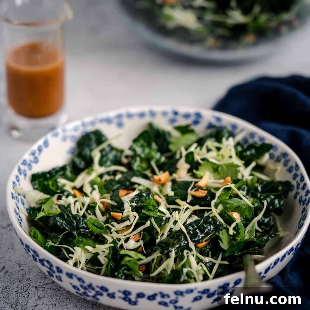Hearty crunchy kale salad with spicy peanut vinaigrette
