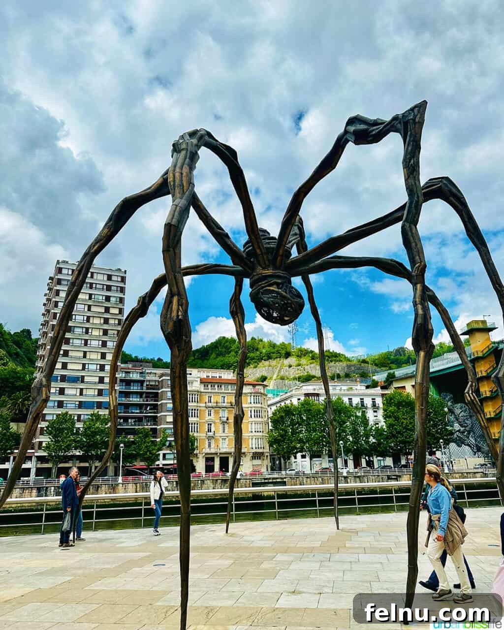 Bilbao Unveiled: Exploring Spain's Basque Masterpiece 11 Maman, Louise Bourgeois's colossal bronze spider sculpture, positioned majestically outside the Guggenheim Museum Bilbao.