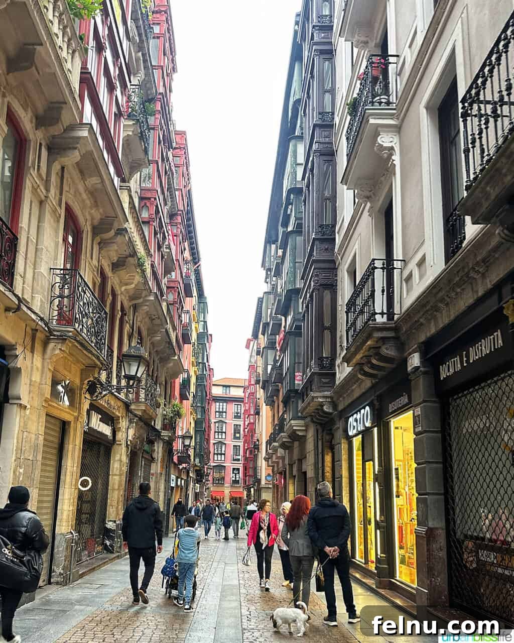 Bilbao Unveiled: Exploring Spain's Basque Masterpiece 12 A lively street scene in Casco Viejo (Old Town) Bilbao, Spain, with traditional buildings, bustling activity, and vibrant atmosphere.
