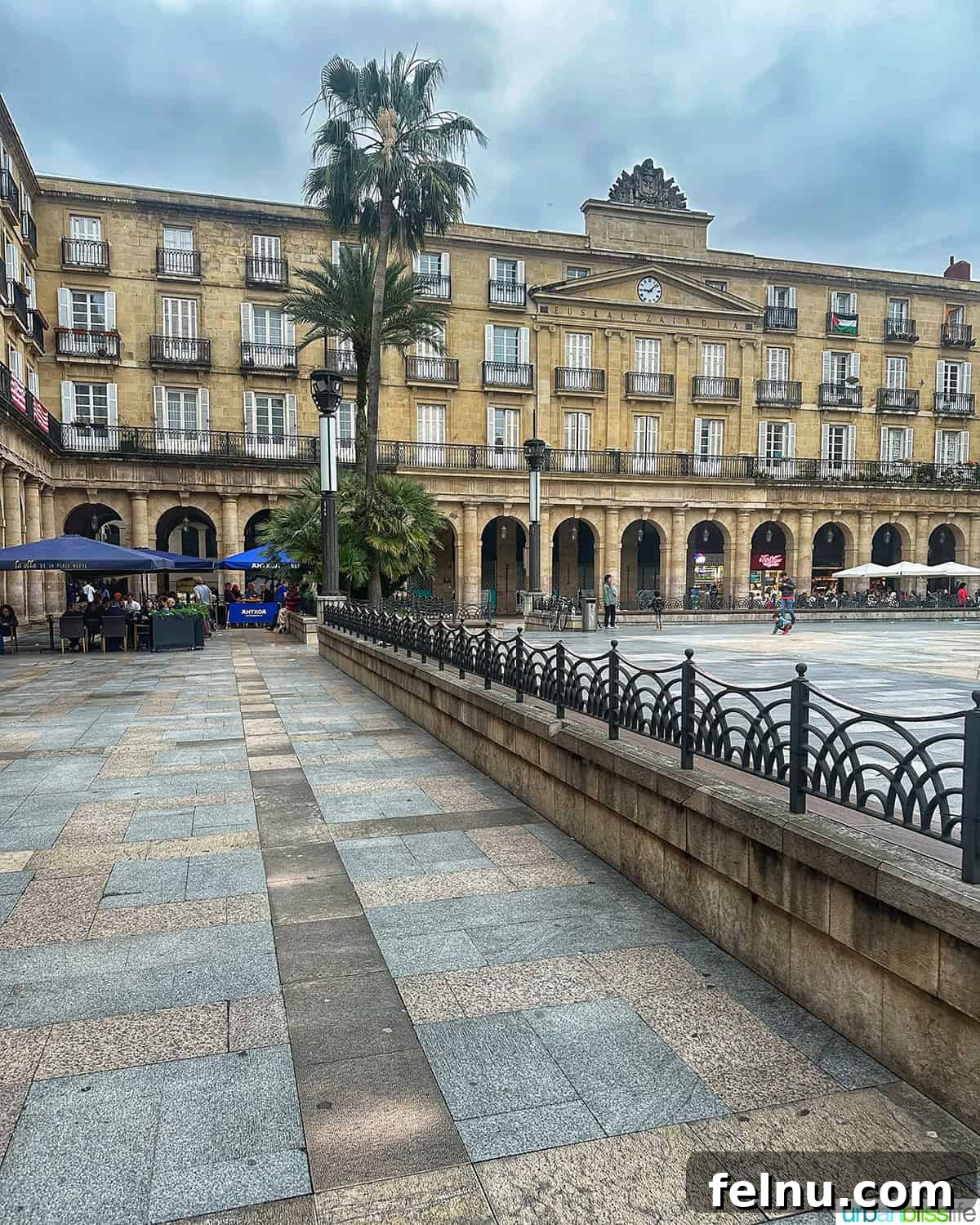 Bilbao Unveiled: Exploring Spain's Basque Masterpiece 13 The impressive Plaza Nueva in Bilbao's Casco Viejo Old Town, featuring its iconic neoclassical architecture and bustling activity.