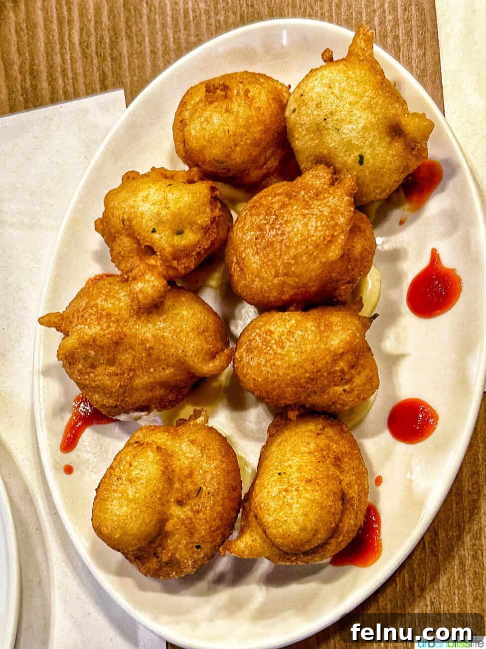Bilbao Unveiled: Exploring Spain's Basque Masterpiece 24 Crispy and flavorful Cod Fritters, a classic Basque delicacy, served at Los Fueros restaurant.