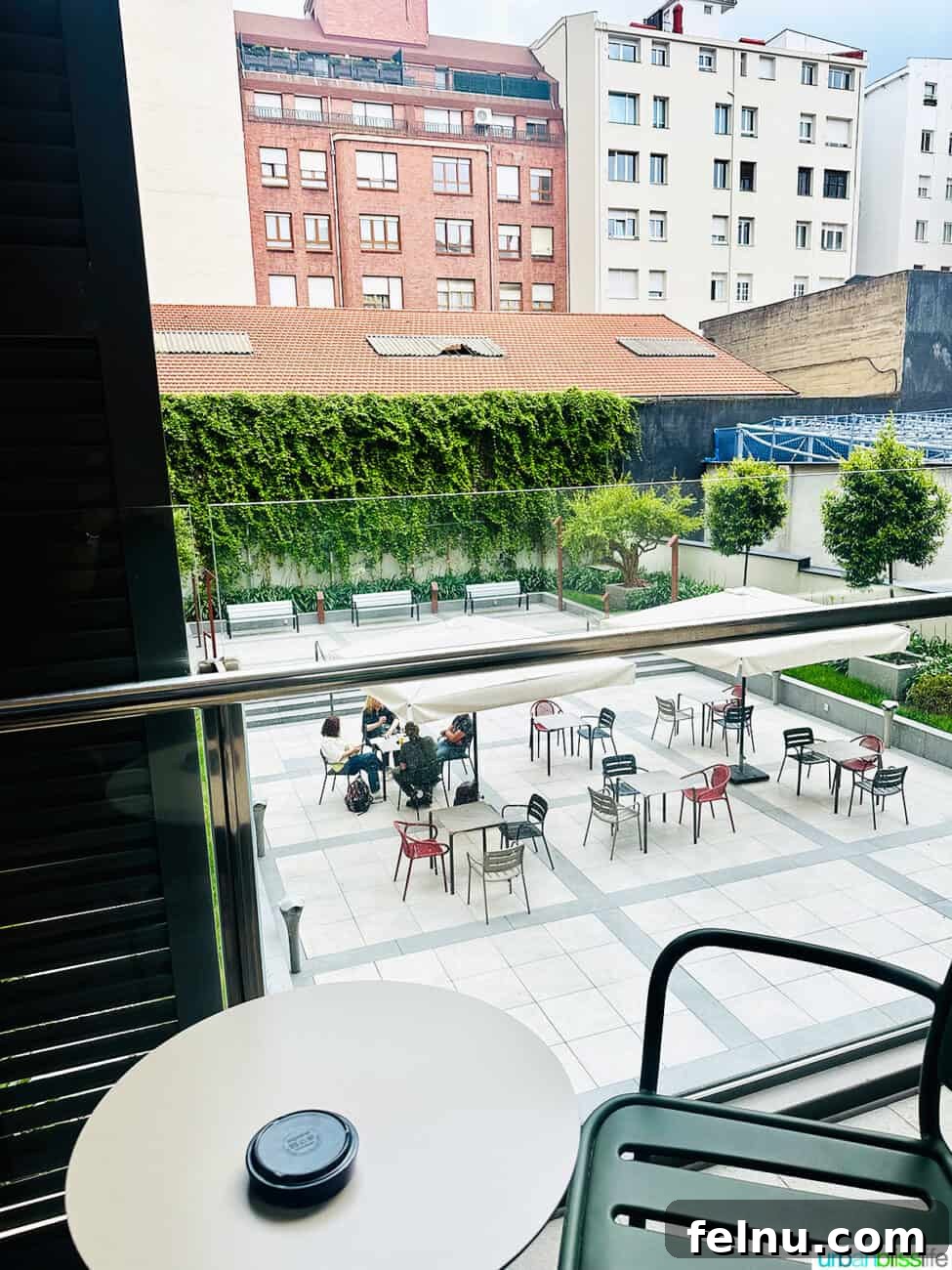 Bilbao Unveiled: Exploring Spain's Basque Masterpiece 36 A stylish outdoor terrace at Hotel Ilunion San Mamés in Bilbao, offering a comfortable seating area.