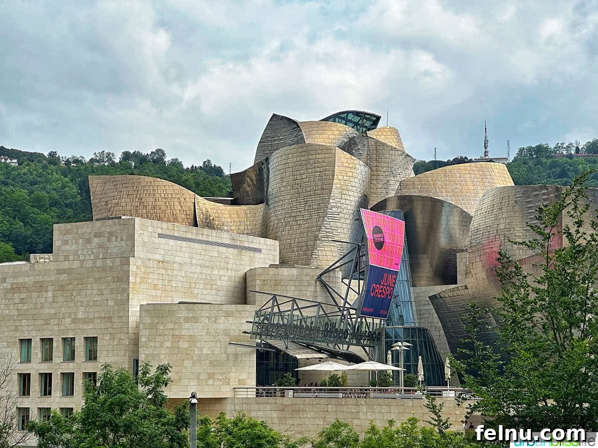 Bilbao Unveiled: Exploring Spain's Basque Masterpiece 5 The stunning, curvilinear exterior of the Guggenheim Museum in Bilbao, Spain, shimmering under natural light.
