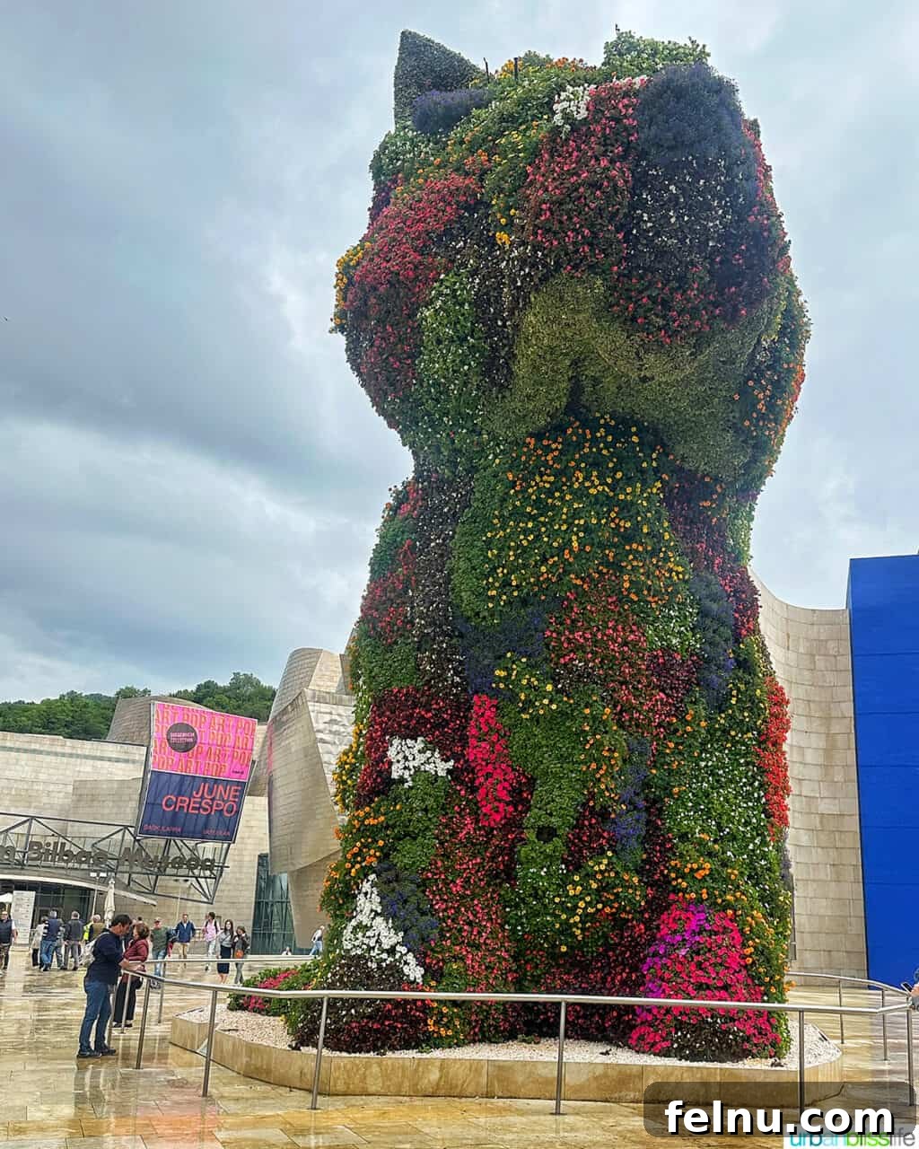 Bilbao Unveiled: Exploring Spain's Basque Masterpiece 7 Jeff Koons' PUPPY floral sculpture, a giant West Highland White Terrier covered in thousands of vibrant living flowers, standing guard outside the Guggenheim Museum Bilbao.