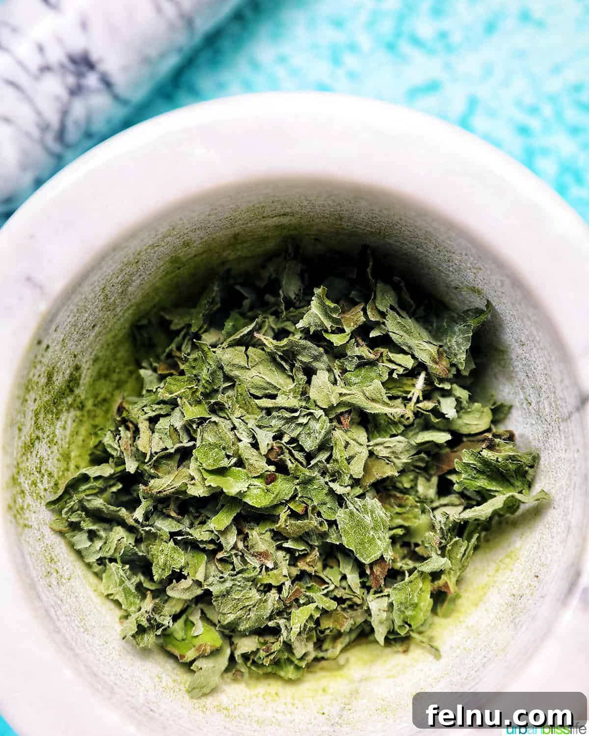 How to Dry Oregano at Home 2 dried oregano leaves in a marble bowl.