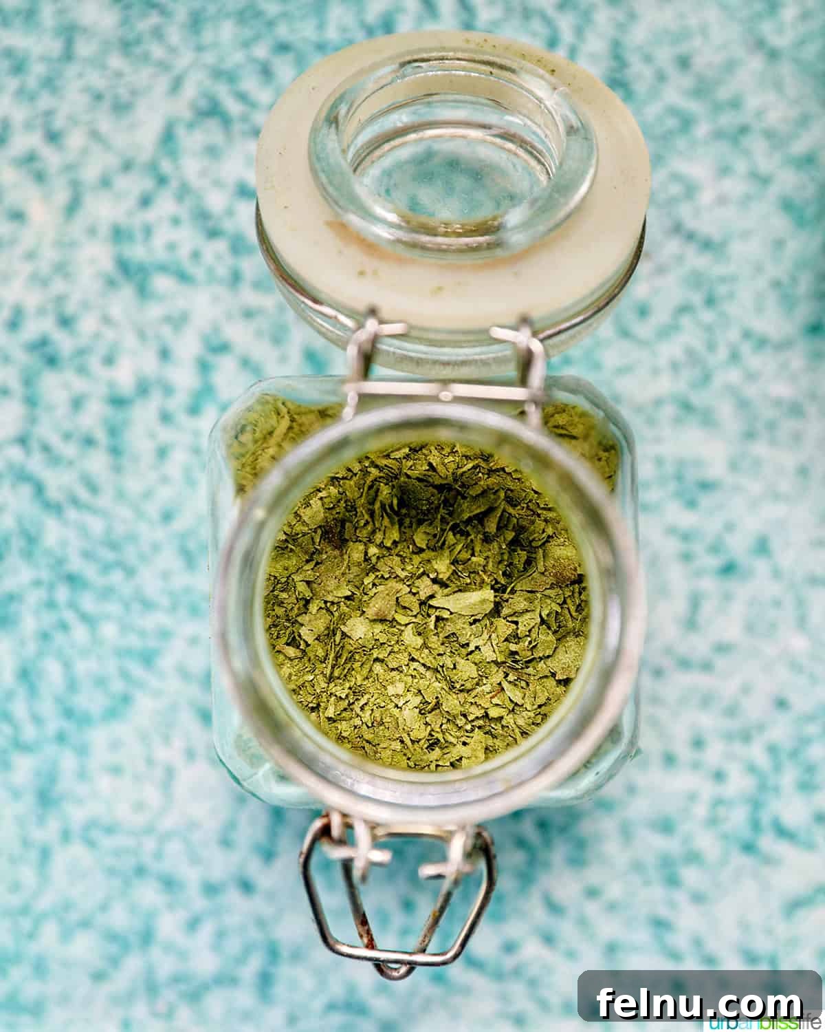 How to Dry Oregano at Home 3 dried oregano leaves in an open mason jar.
