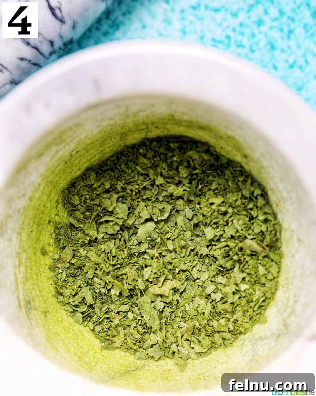 How to Dry Oregano at Home 9 crushed dried oregano leaves in a marble bowl.