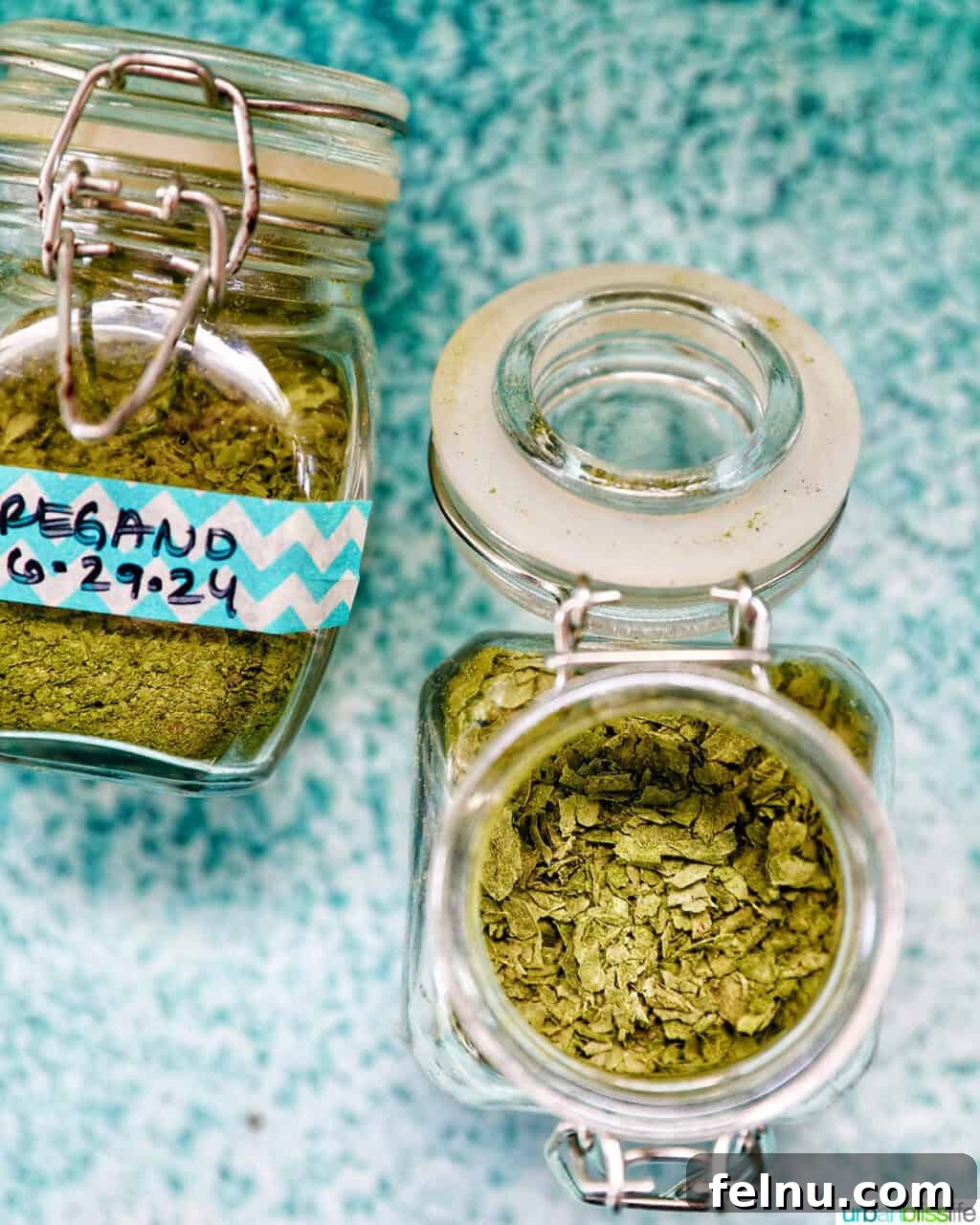 How to Dry Oregano at Home 10 dried oregano in labeles jars with one jar open to reveal the leaves.