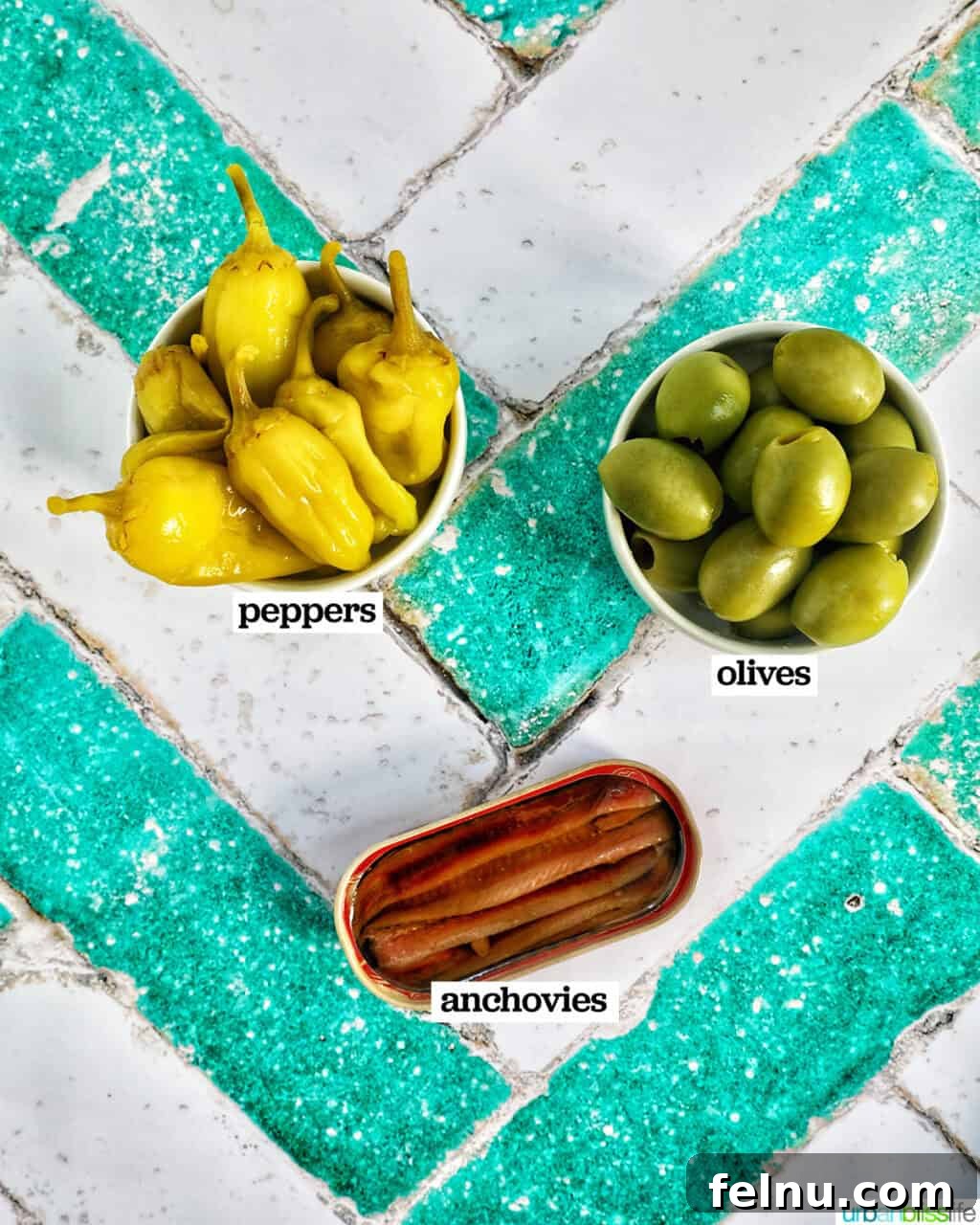 Gilda A Basque Classic 4 Bowls of pickled guindilla peppers, high-quality anchovies, and green Manzanilla olives, the essential Gilda pintxo ingredients.