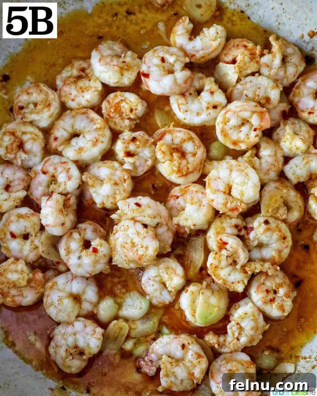 Savory Shrimp Bites 10 gambas al ajillo in a white pan.