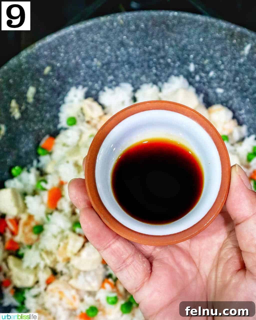 Shrimp and Chicken Stir-Fry Rice Bowl 14 Adding soy sauce to the fried rice