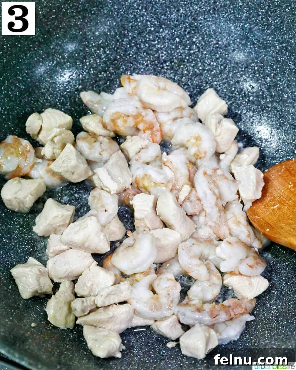 Shrimp and Chicken Stir-Fry Rice Bowl 8 Cooked chicken pieces in a wok
