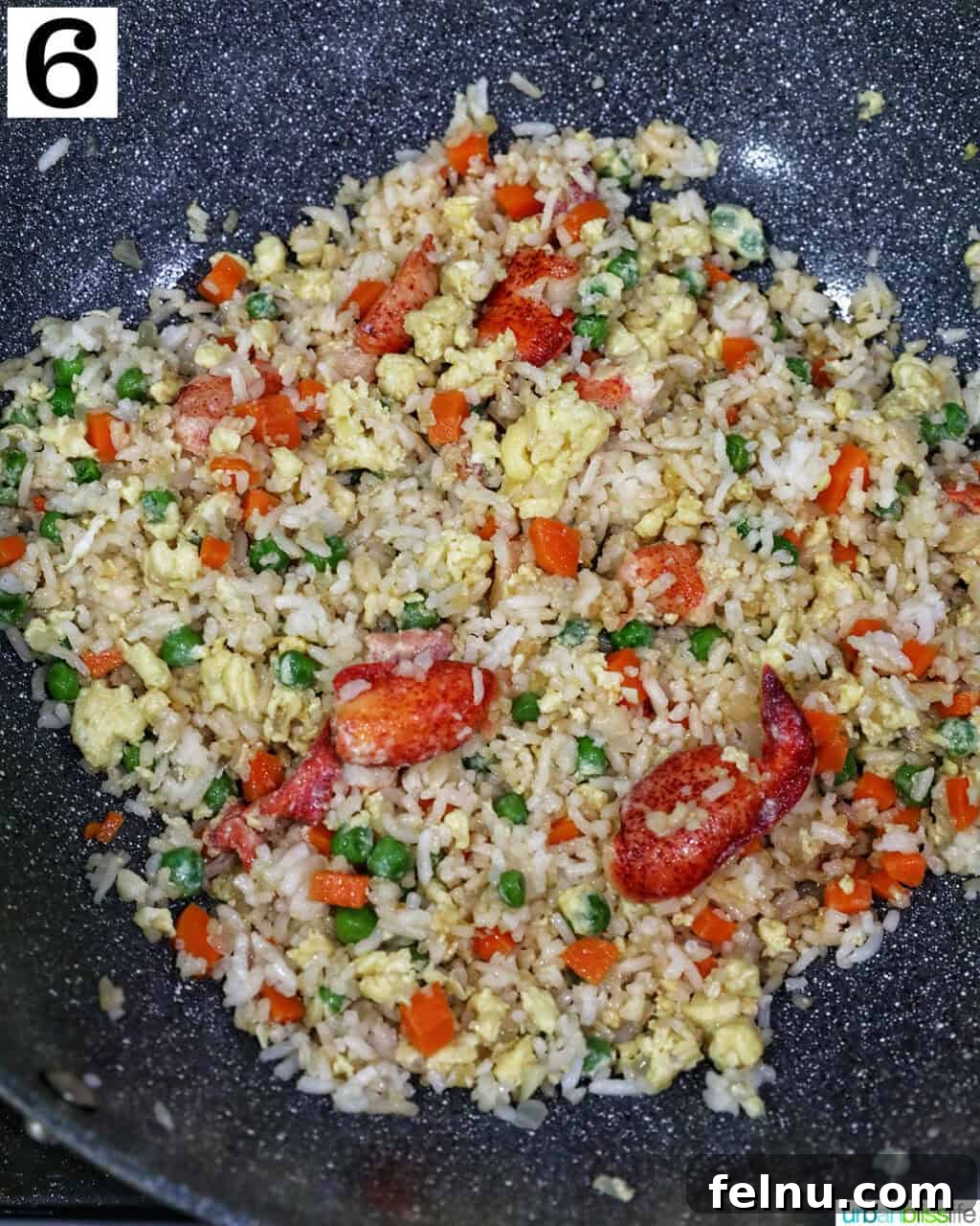 Decadent Lobster Fried Rice 13 wok with lobster fried rice in it.