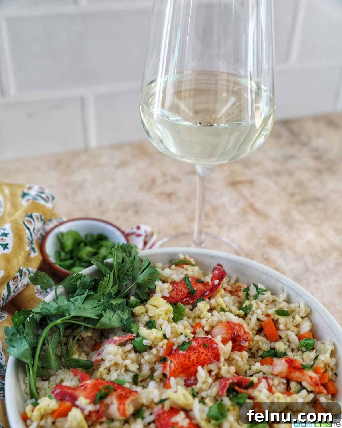 Decadent Lobster Fried Rice 16 bowl of lobster fried rice with bowls of fresh herbs and a glass of white wine.