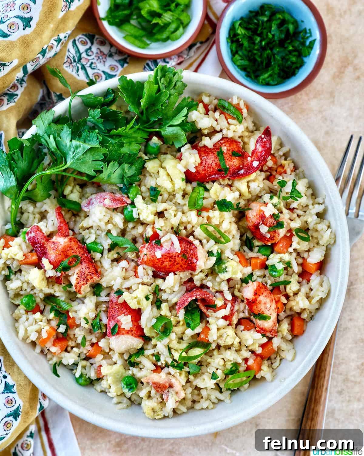Decadent Lobster Fried Rice 3 bowl of lobster fried rice with bowls of fresh herbs, a napkin, and a fork.