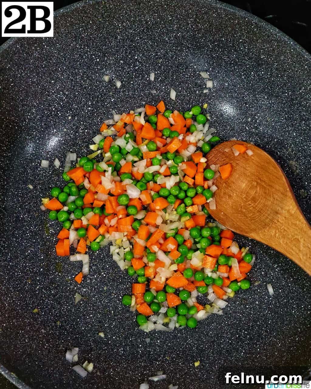 Decadent Lobster Fried Rice 7 wok with vegetables and a wooden spoon.