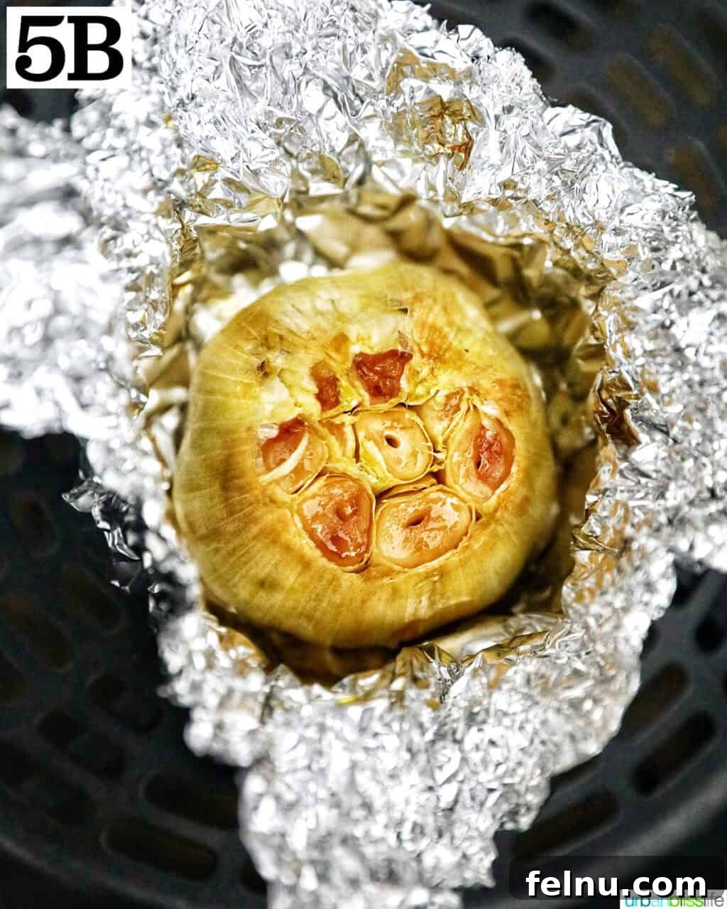 Golden Butternut Squash and Roasted Garlic Spread 10 aluminum foil open to roasted garlic head.