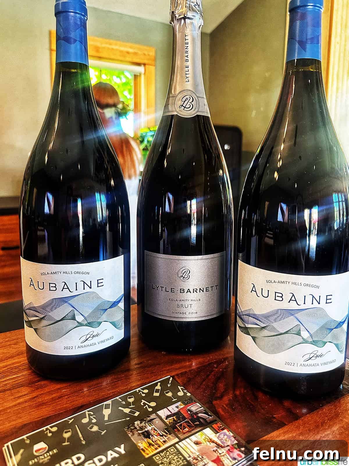 Lytle-Barnett & Aubaine Vintners Lounge 3 Elegant bottles of Lytle-Barnett sparkling wine and Aubaine still wines displayed together.