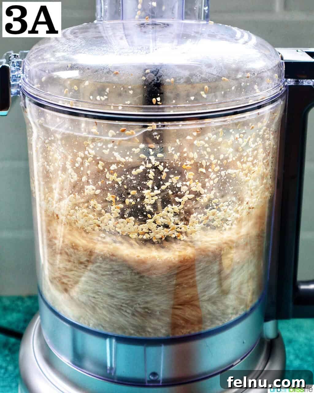 Crafting Your Own Tahini 8 food processor with sesame seeds.