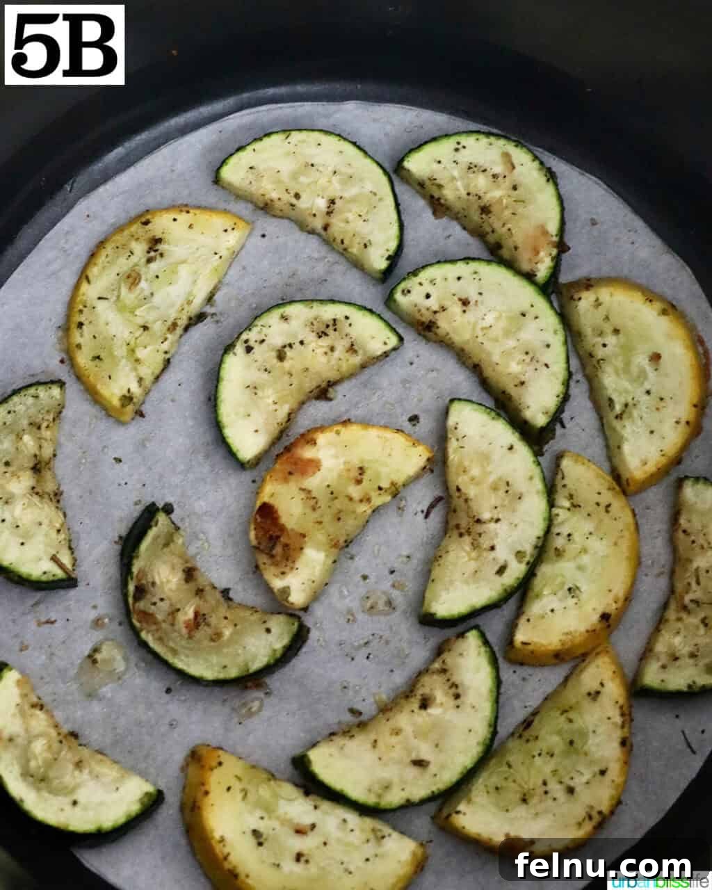 Air Fryer Zucchini and Squash Medley 12 Air-fried zucchini and yellow squash in an air fryer basket