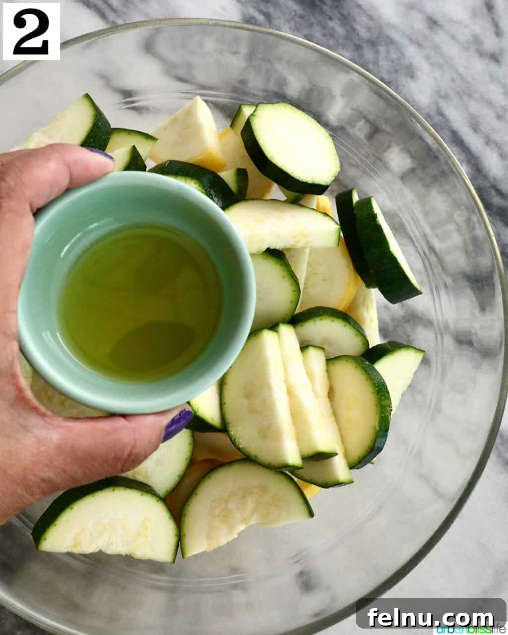 Air Fryer Zucchini and Squash Medley 6 Adding olive oil to zucchini and yellow squash