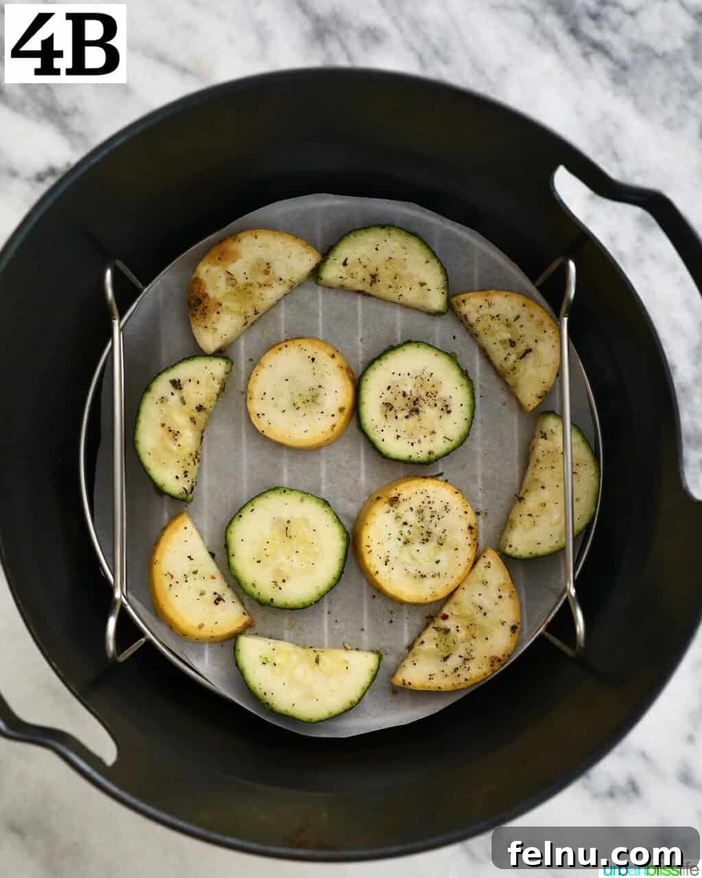 Air Fryer Zucchini and Squash Medley 10 Air-fried zucchini and yellow squash in an air fryer basket