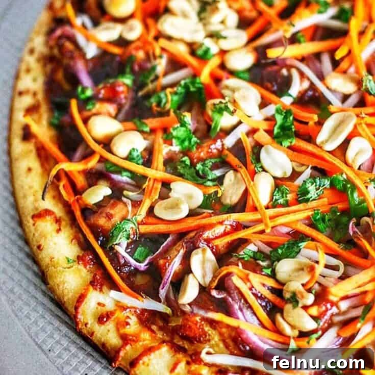 A slice of CPK-style Thai Chicken Pizza, a copycat dairy-free version.