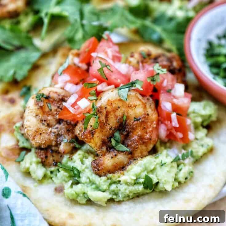 Colorful Shrimp Tostadas topped with fresh pico de gallo and guacamole.