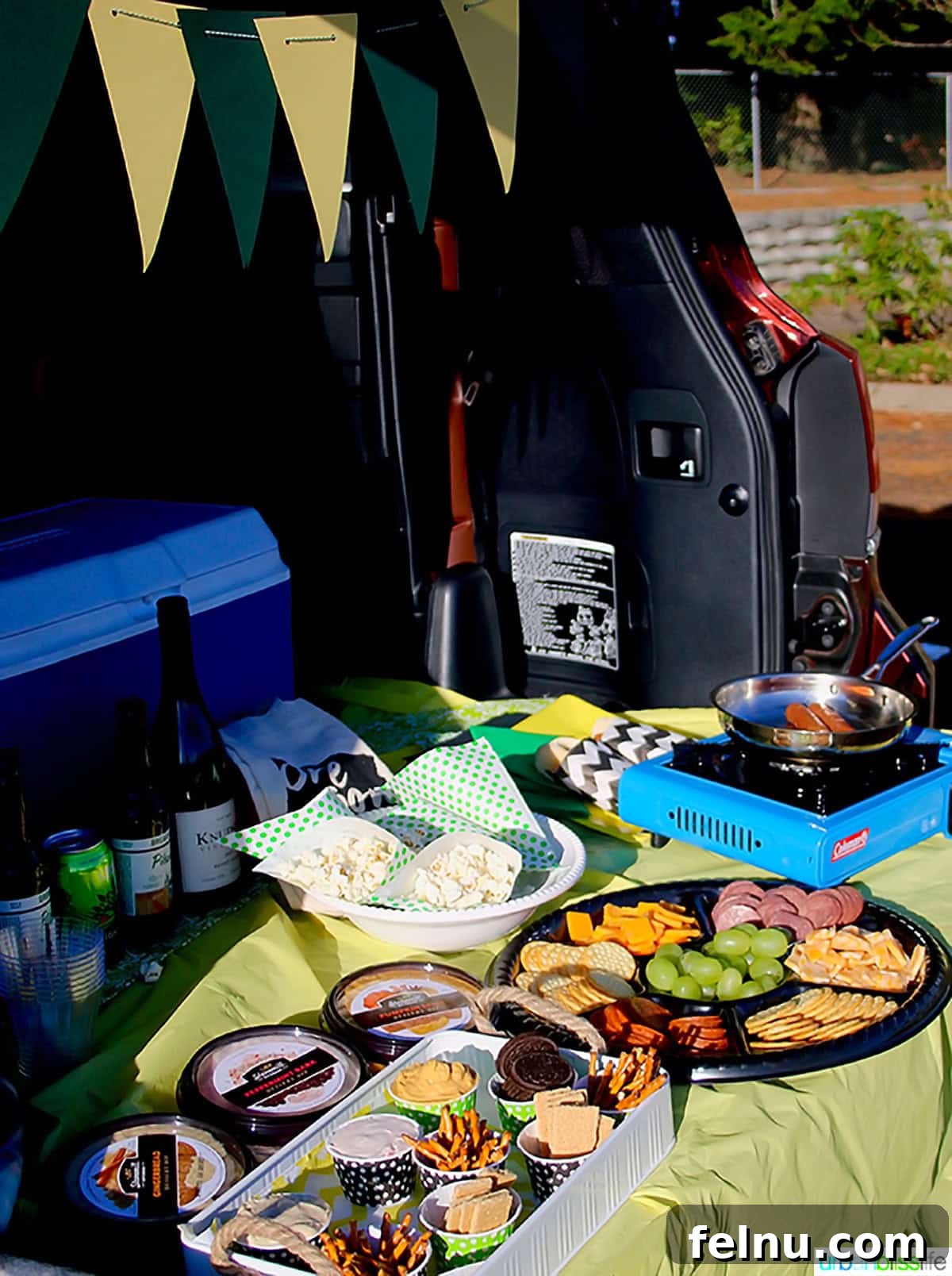 Ultimate Game Grub 4 A festive tailgating food spread laid out in the back of a car, ready for a stadium party.
