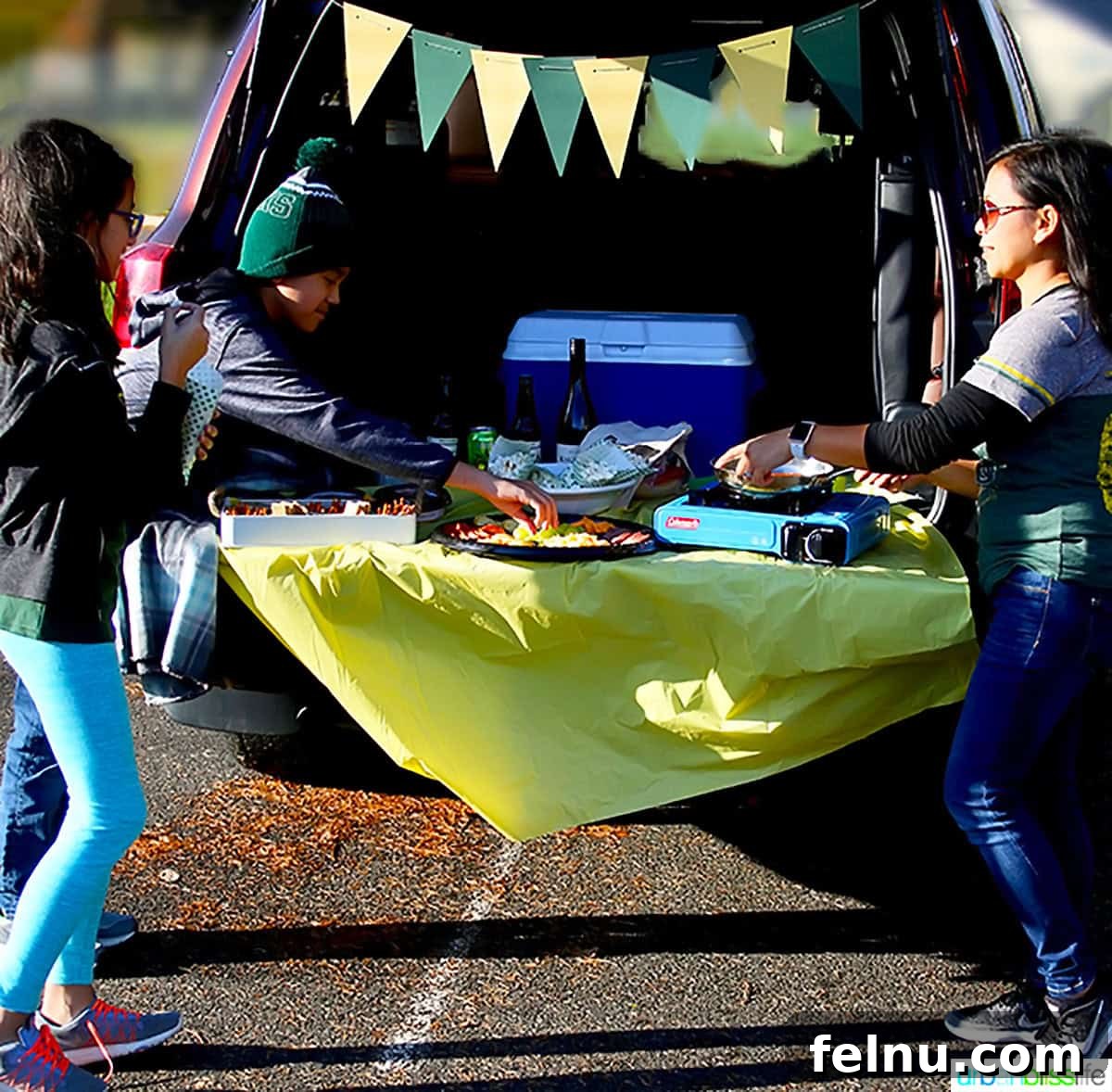 Ultimate Game Grub 5 Marlynn and her children enjoying a tailgating party with food and drinks.