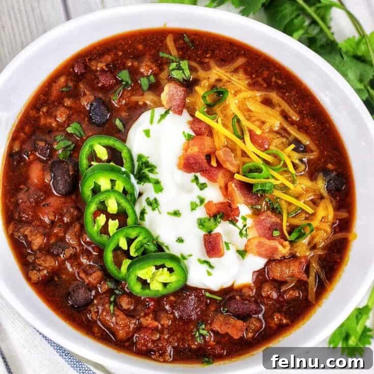 A hearty bowl of Instant Pot Turkey and Bean Chili, garnished with toppings, ready for Game Day.