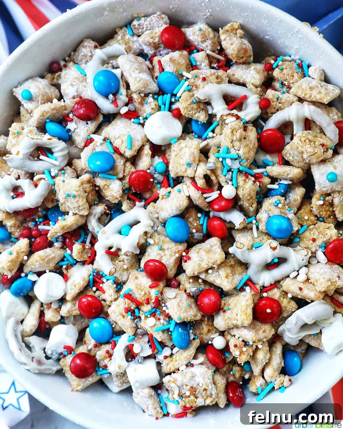 Effortlessly Delicious Patriotic Puppy Chow 2 Large bowl filled with festive red, white, and blue patriotic puppy chow, ready to be served.